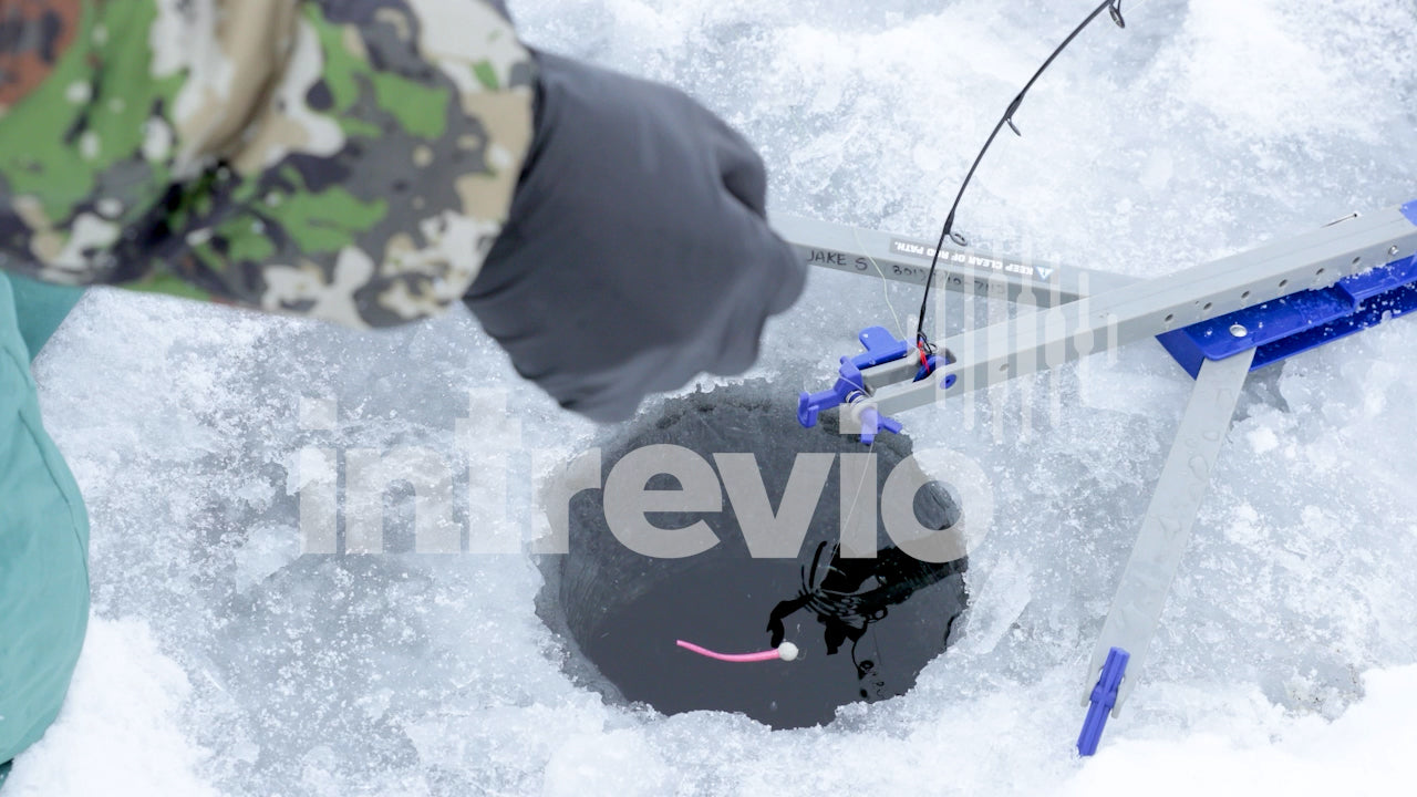 Dropping Lure into Ice Fishing Hole-02