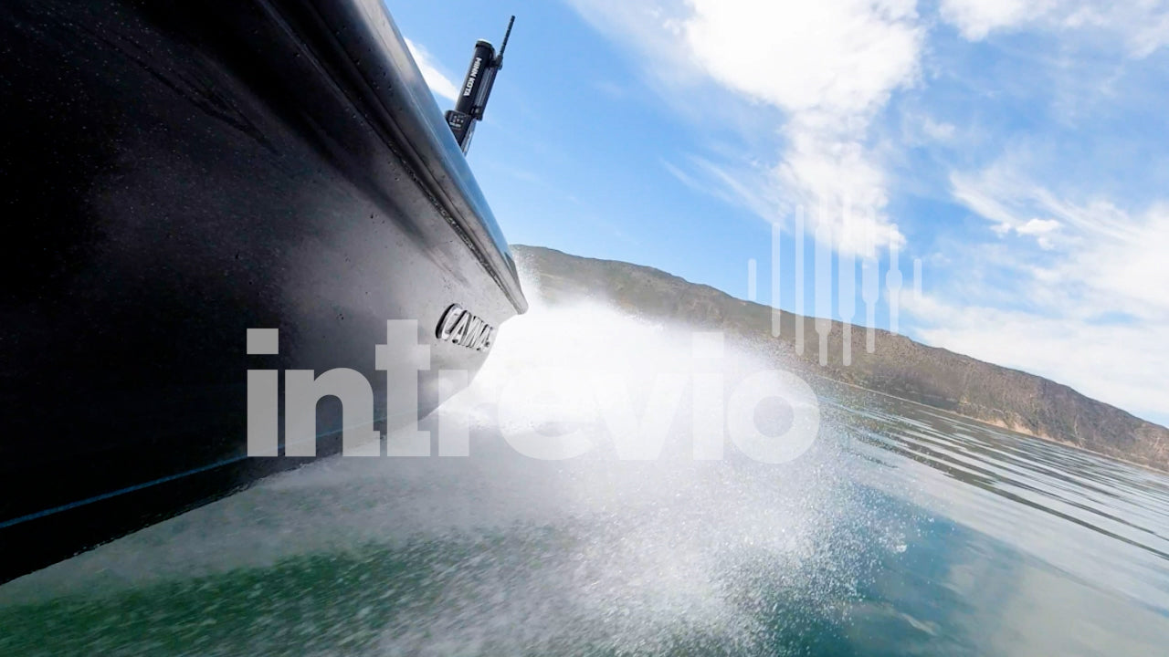 Side of Fishing Boat Close to Water with Wake - Caymas