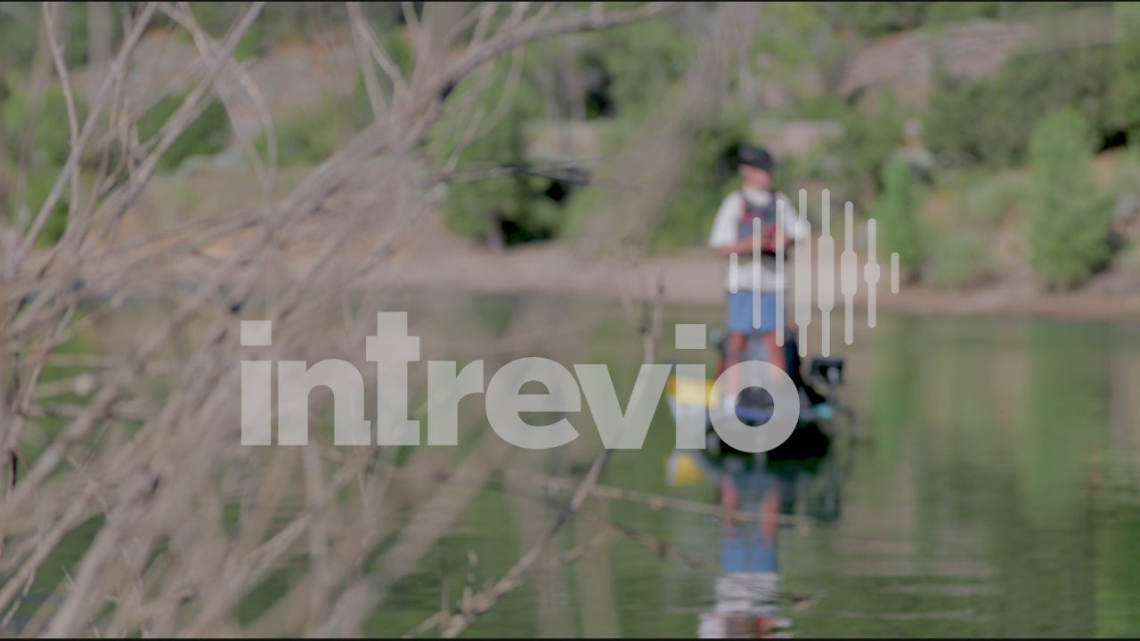 Standing and Fishing in Kayak Rack Focus to Bush