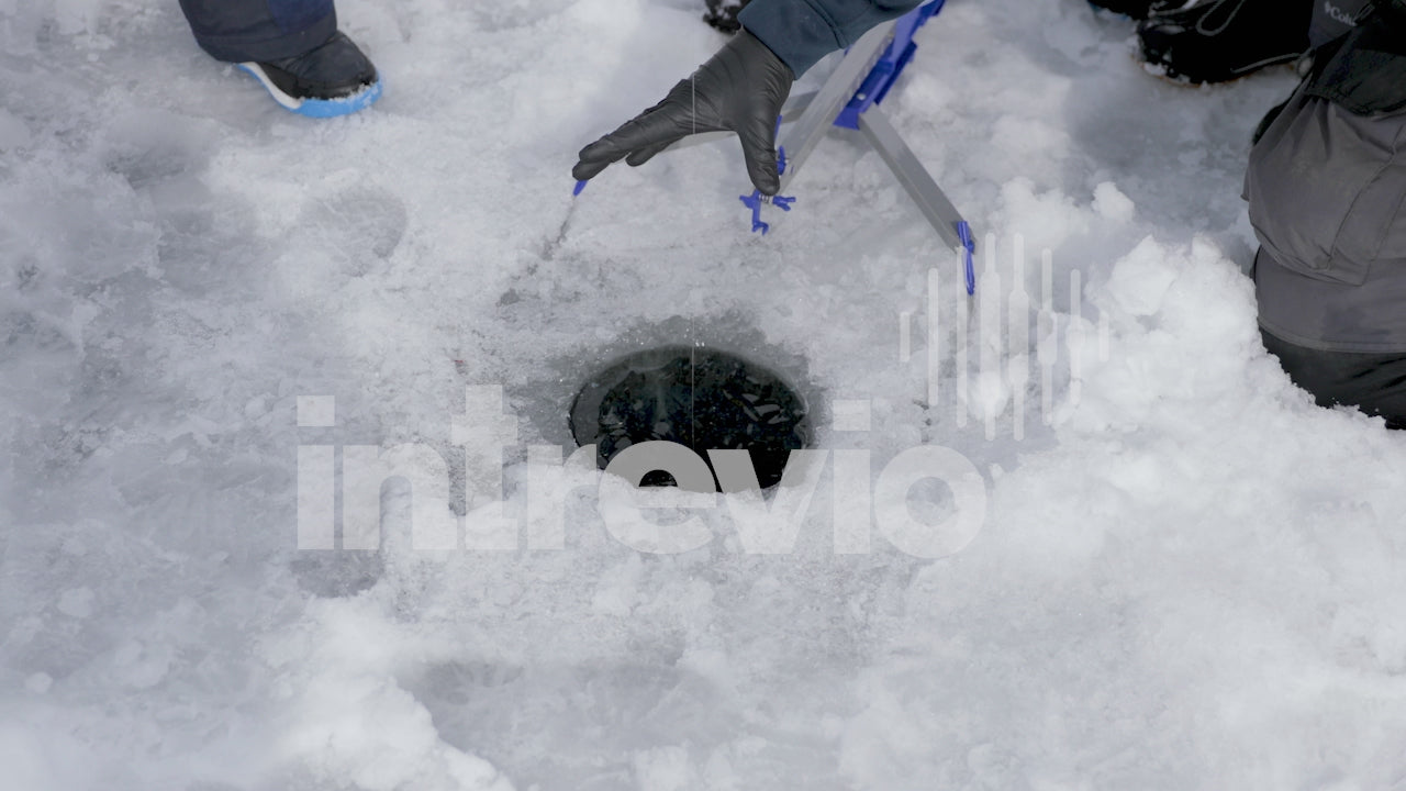 Catching Rainbow Trout Through Ice Fishing Hole