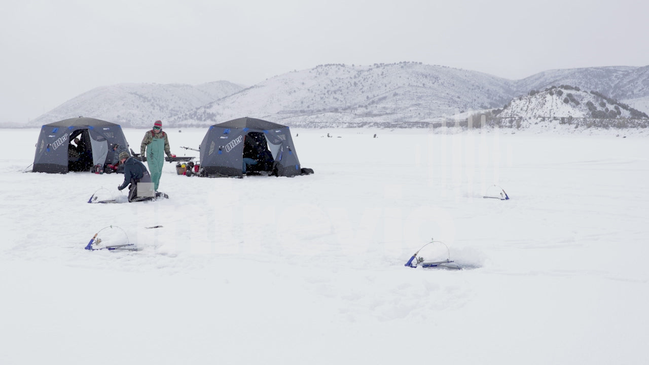 Fishermen Setting Up Ice Fishing Camp in Light Snow